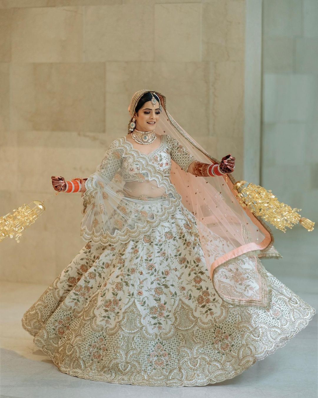 Bride twirling in white embroidered lehenga