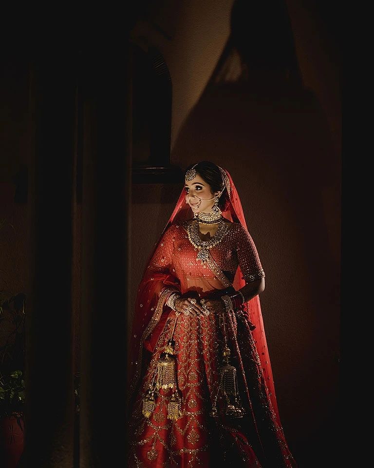 Bride in red lehenga, cinematic shadow and light